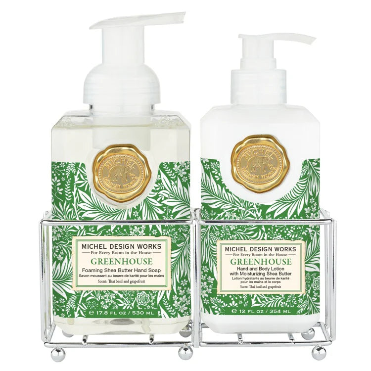 Two bottles of Michel Design Works Greenhouse hand soap in a decorative stand on a white background.