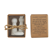 Pocket nativity set with a cardboard box containing religious text on a white background