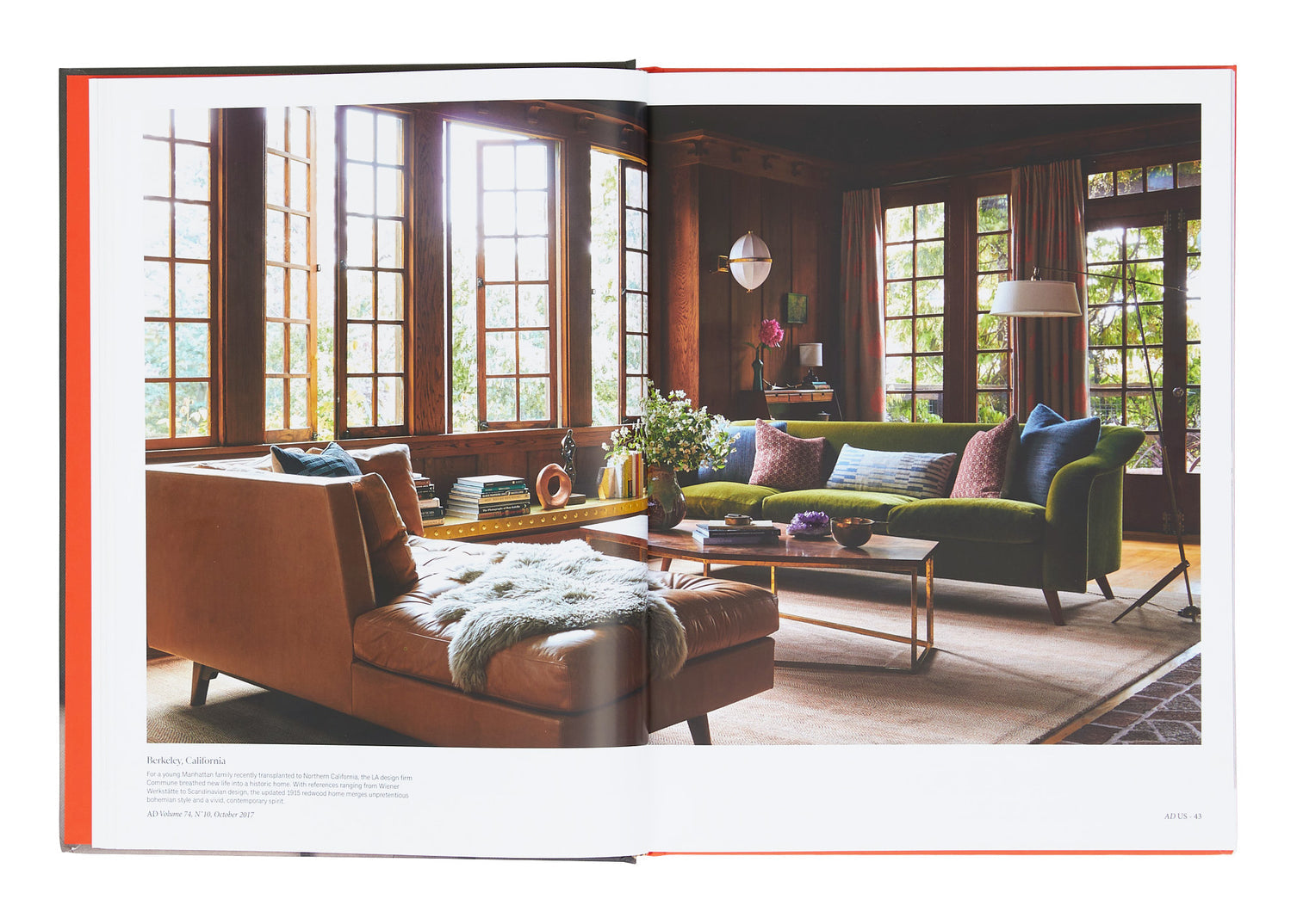 Open book showing a living room with a green sofa and brown chair.