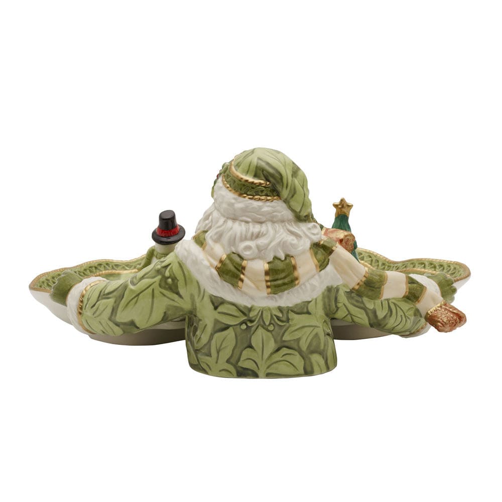 Decorative figurine of a stylized Santa Claus in green and white attire on a white background