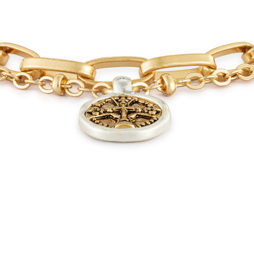Gold chain bracelet with a silver tag featuring a tree of life design on a white background