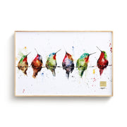 Framed artwork of colorful birds on a wire against a white background