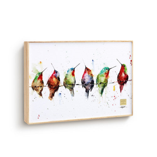 Framed artwork of colorful hummingbirds on a white background