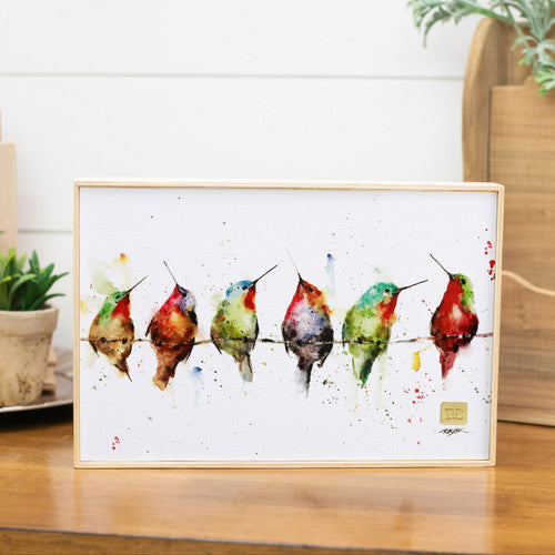 Framed artwork of colorful birds on a branch with a white background