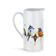 White ceramic pitcher with colorful bird design on a white background