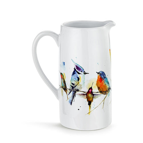 White ceramic pitcher with colorful bird design on a white background