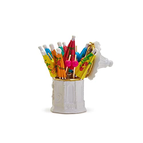 Colorful cocktail  picks that are paper umbrellas and beads in a white pagoda shaped holder on a white background
