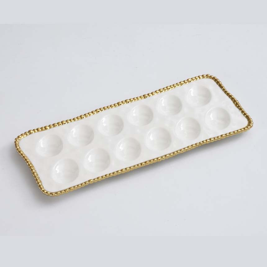 Pampa Bay brand Rectangular white egg tray dish with gold ball rim on a light gray background 
