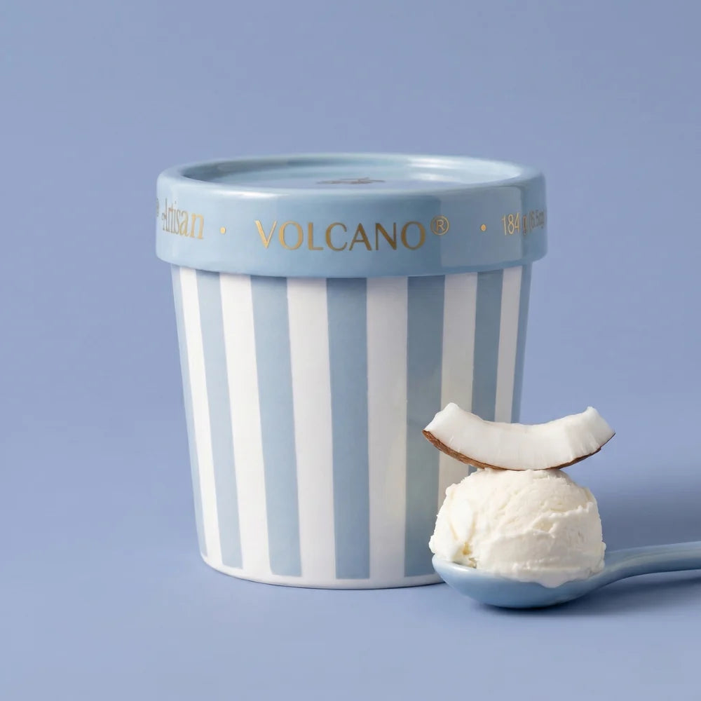 Volcano candle on blue background with ice cream and coconut 