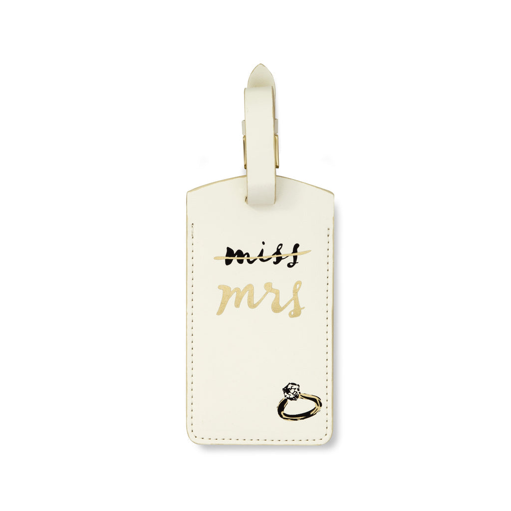 Cream-colored luggage tag with 'Miss Mrs.' text and ring design on a white background