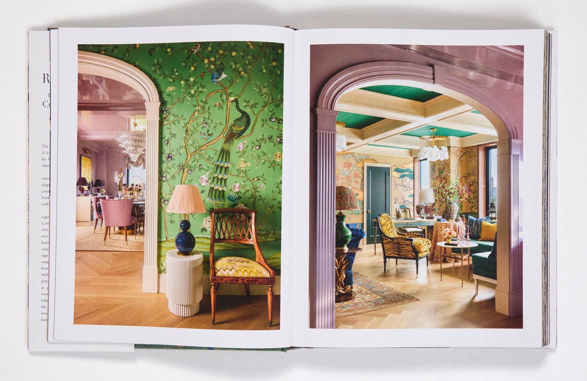 Open book showing interior design images of a room with green walls and wooden furniture.