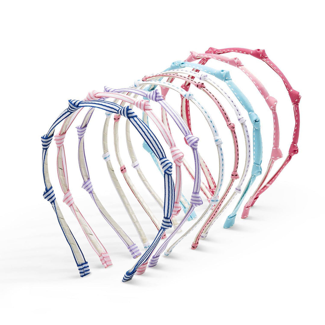 Set of colorful ribbon knotted kids headbands on a white background