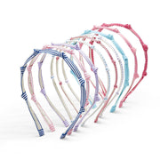 Set of colorful ribbon knotted kids headbands on a white background