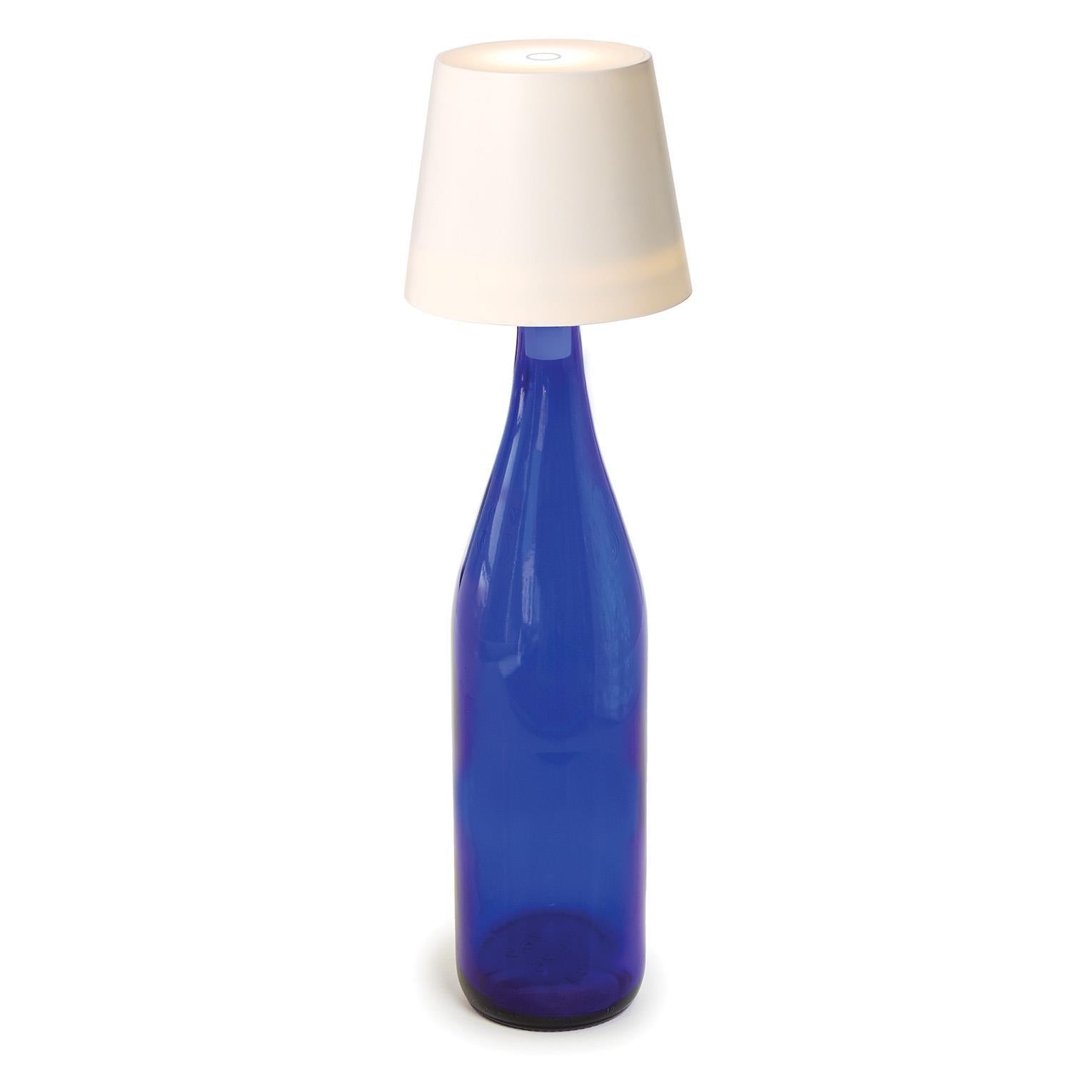 Blue bottle-shaped lamp with a white lampshade on a white background