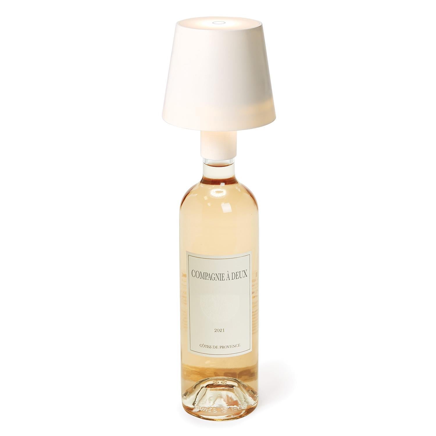 Bottle of Céramique de l'In with a white lampshade on a white background