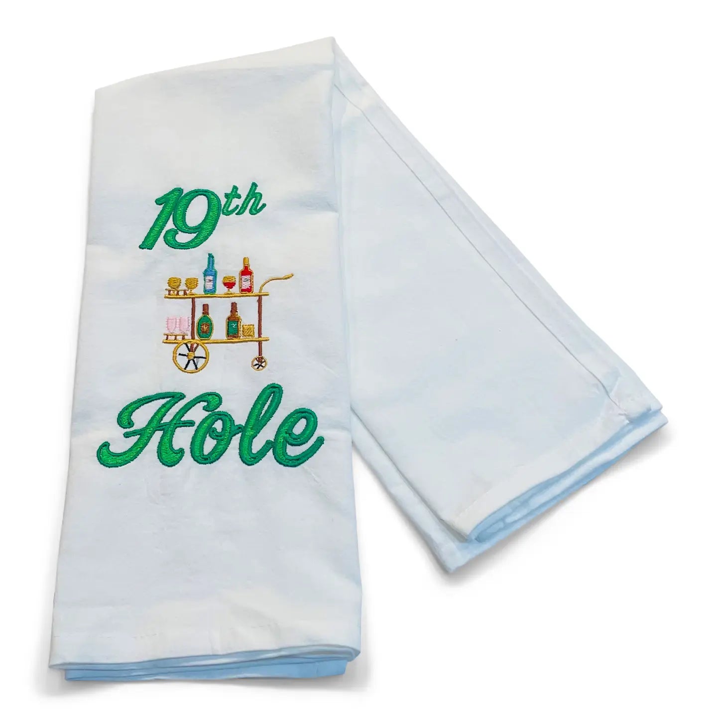 Folded white towel with '19th Hole' text and bar cart design on a white background