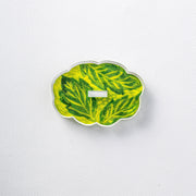 Decorative leaf-patterned object on a white background