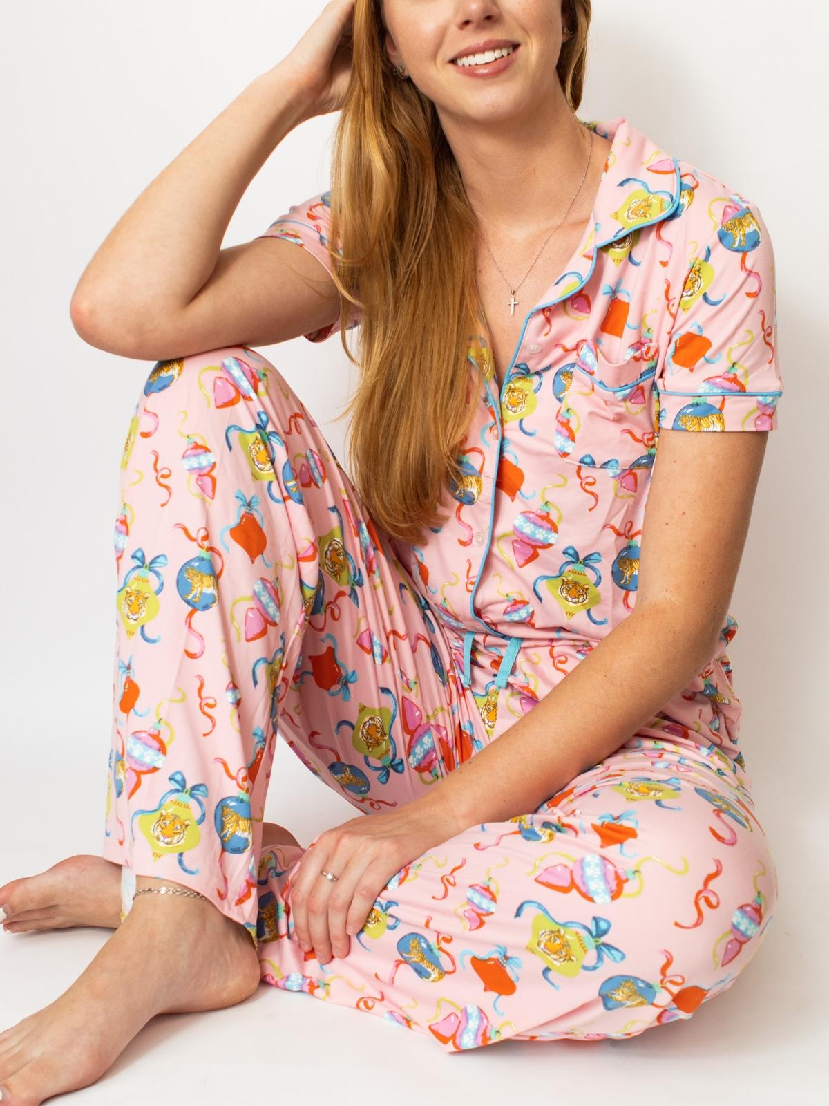 Woman wearing a colorful pajama set with a white background
