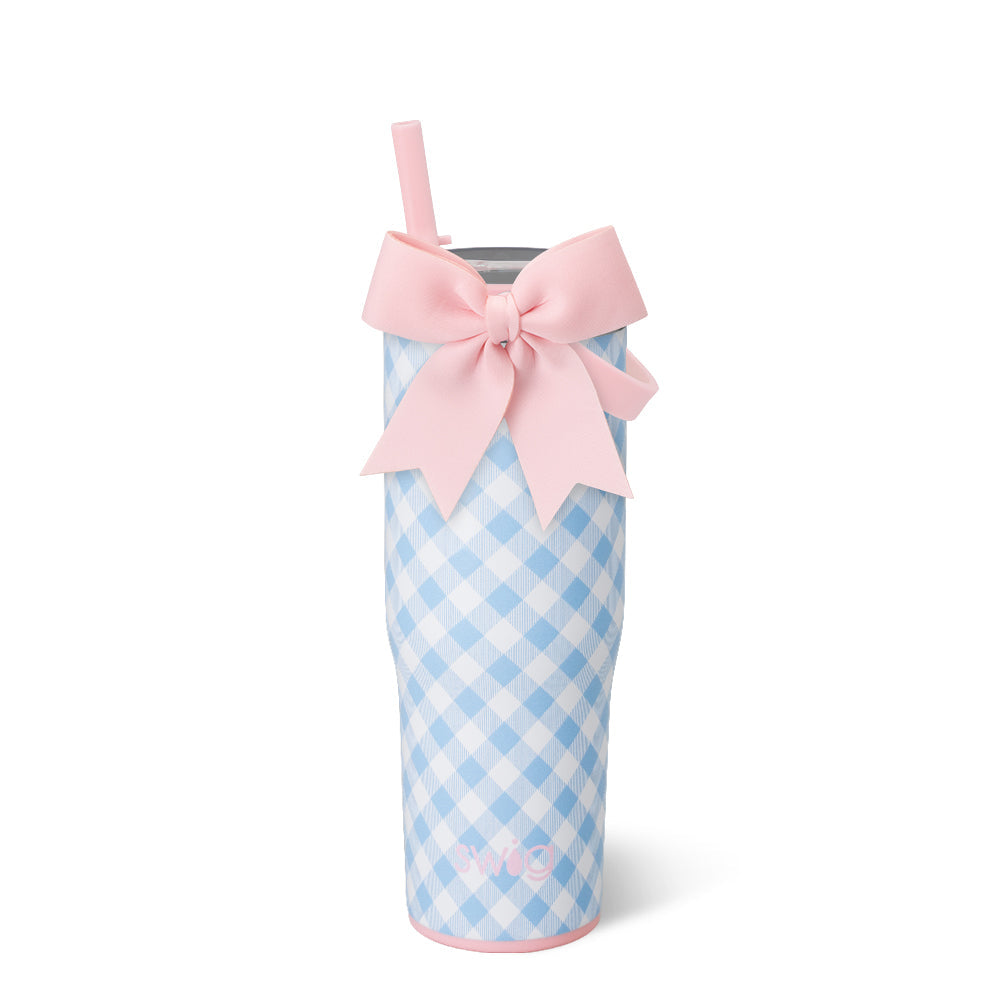 Blue ggham insulated tumber cup with pink bow and strw on white background
