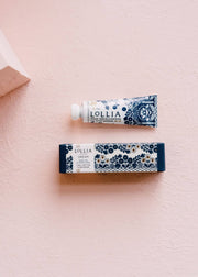 Small dream hand cream and box on a pink background 