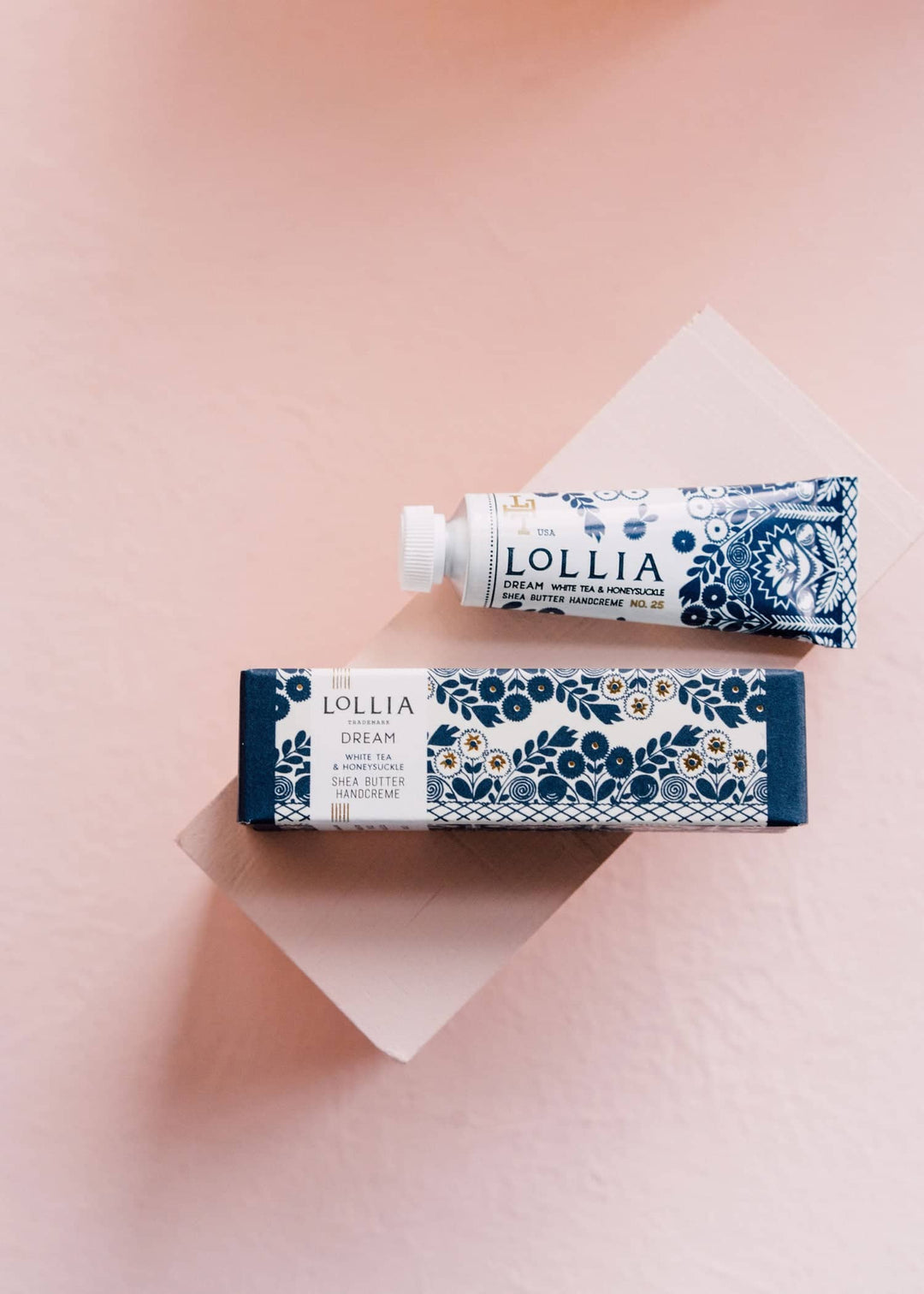 Lollia Dream Hand Cream lotion and box on pink background 
