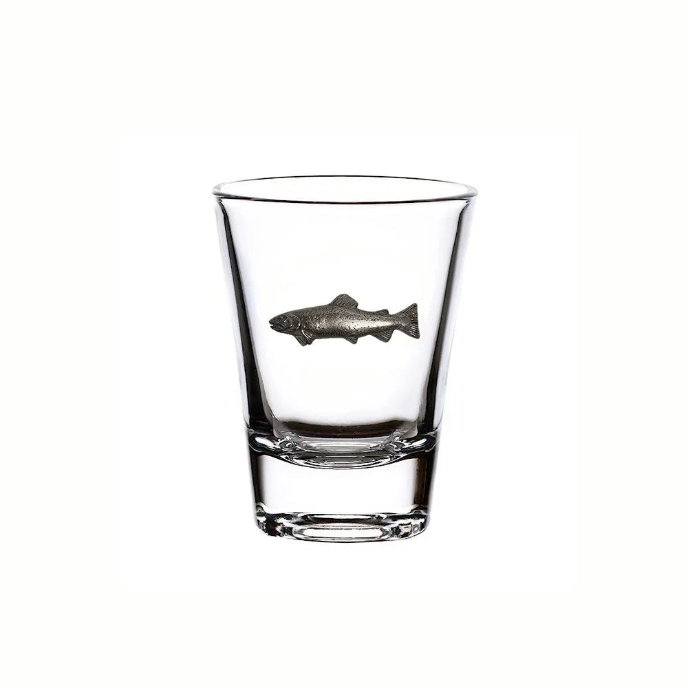 Clear glass shot glass with a fish emblem on a white background
