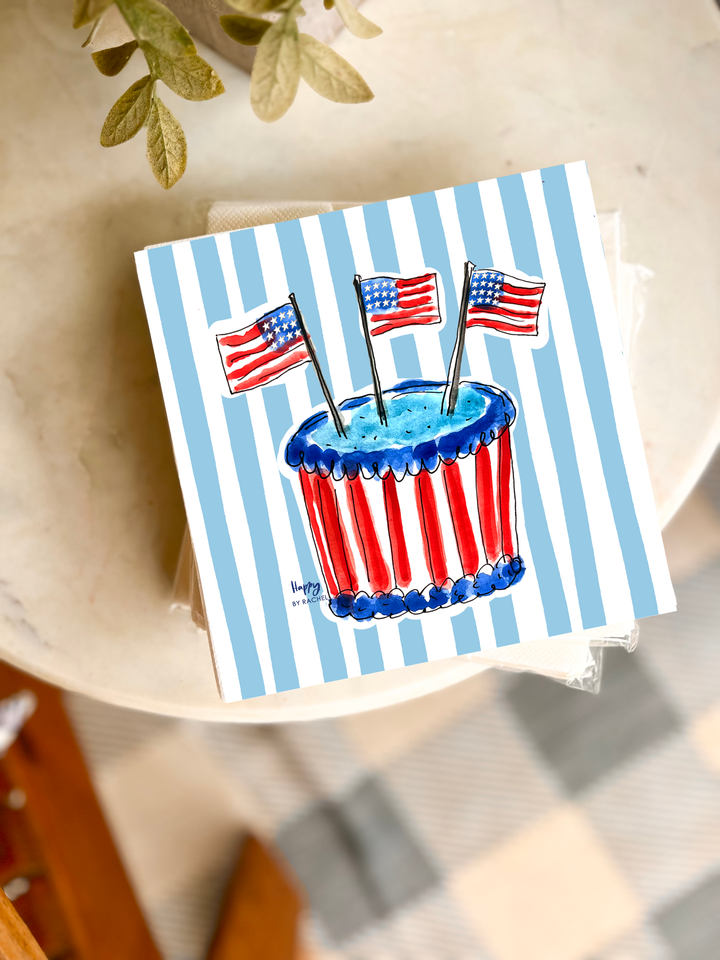 Note card with a patriotic design featuring a cupcake and American flags on a blue and white striped background.