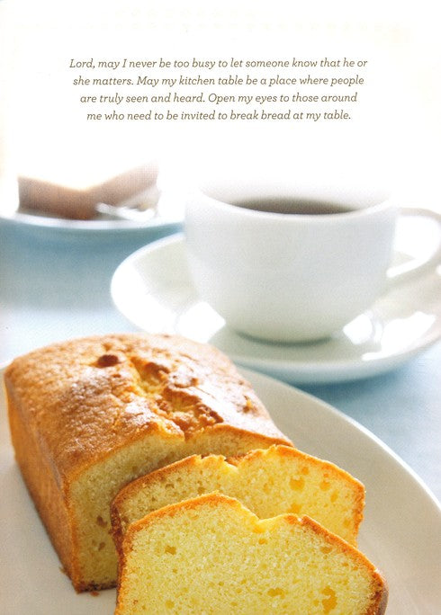 Loaf of bread with slices on a plate with a cup of coffee, set against a white background.