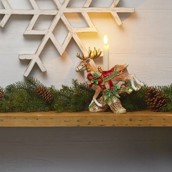 Seasonal - Landing Deer Candle Holder sitting on mantle with candle burning. 