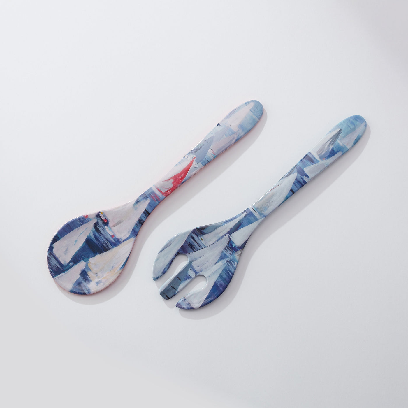 Two patterned spoons on a light gray background