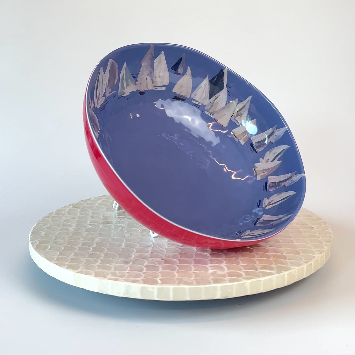 Decorative melamine bowl with sailboat design on a white background
