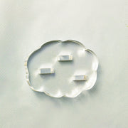Clear cloud-shaped object with embedded smaller rectangular objects on a light gray background