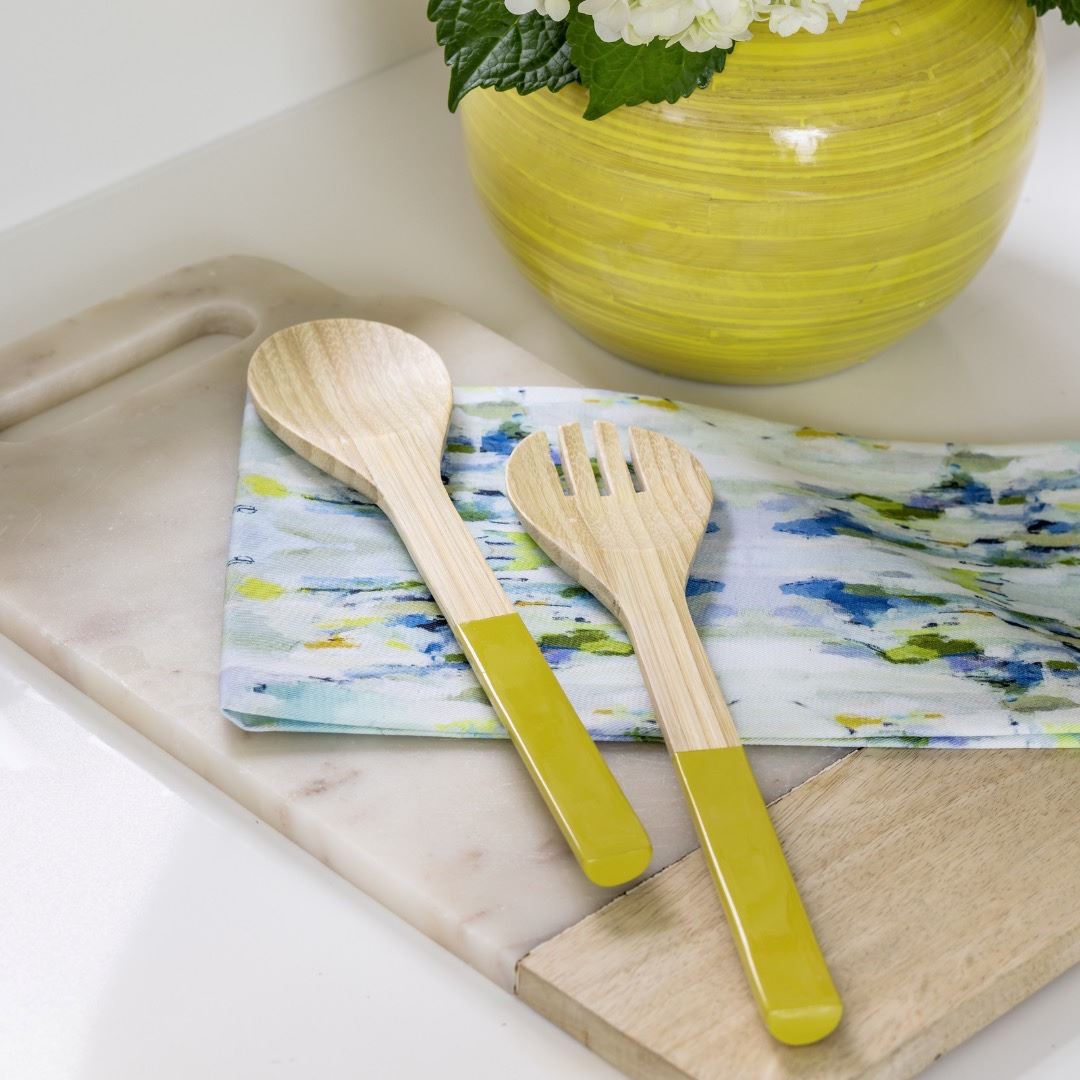 Tea Towel - Wintergreen- in this picture is the wintergreen colorful design tea towel with two wooden spoons resting on a cutting board 