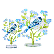 Decorative acrylic birds on branches with flowers on a white background