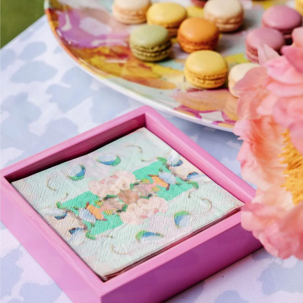 Napkin Holder - Hot Pink Bamboo - Cocktail- pink bamboo napkin holder has colorful napkins in it sitting on a purple blue spotted table with macaroons 