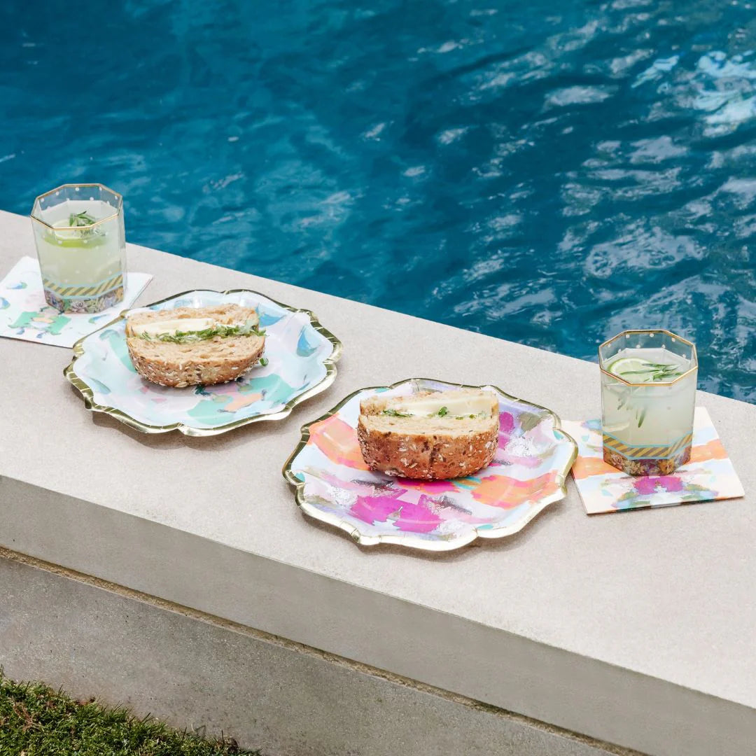 Napkins - Cocktail - Begonia- two colorful napkins with cocktails sitting on top and two colorful plates with sandwiches on them