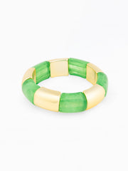 Green and gold bracelet on a white background