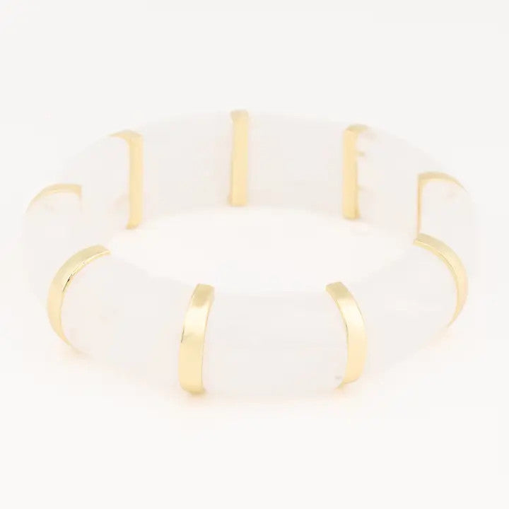 Gold and white bracelet on a white background