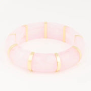 Pink and gold tile stretch bracelet on a white background
