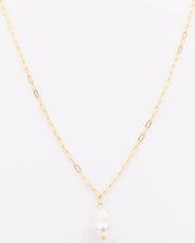 Gold necklace with a pearl pendant on a white background