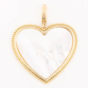 Gold heart-shaped pendant with a white center on a white background