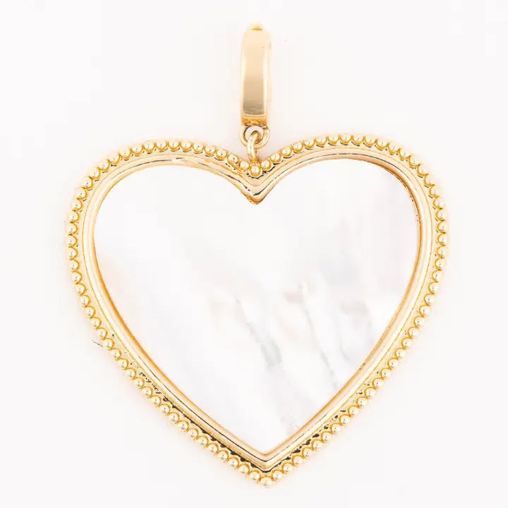 Gold heart-shaped pendant with a white center on a white background