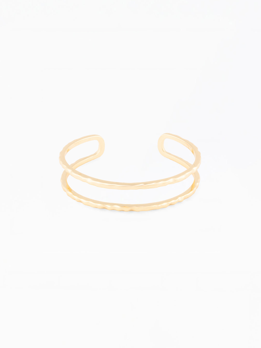 Gold open bangle on a white background