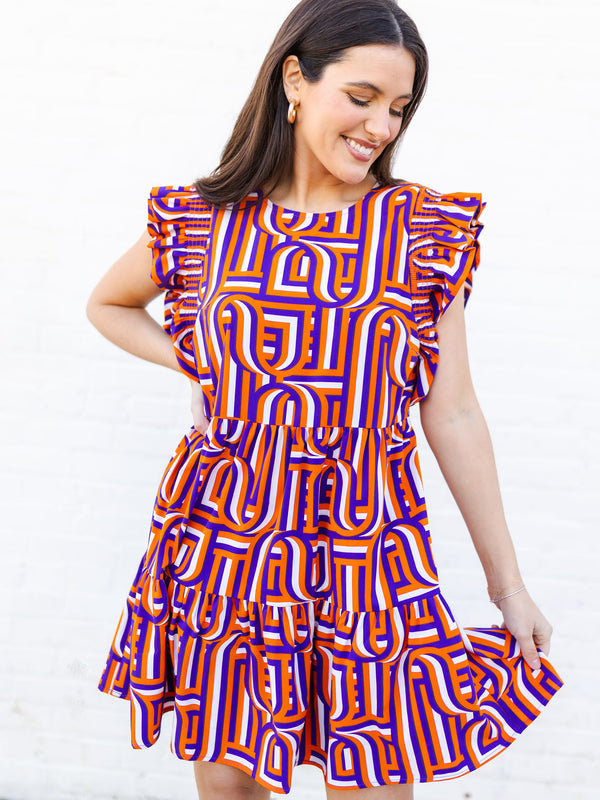 Woman wearing a colorful patterned dress on a white background