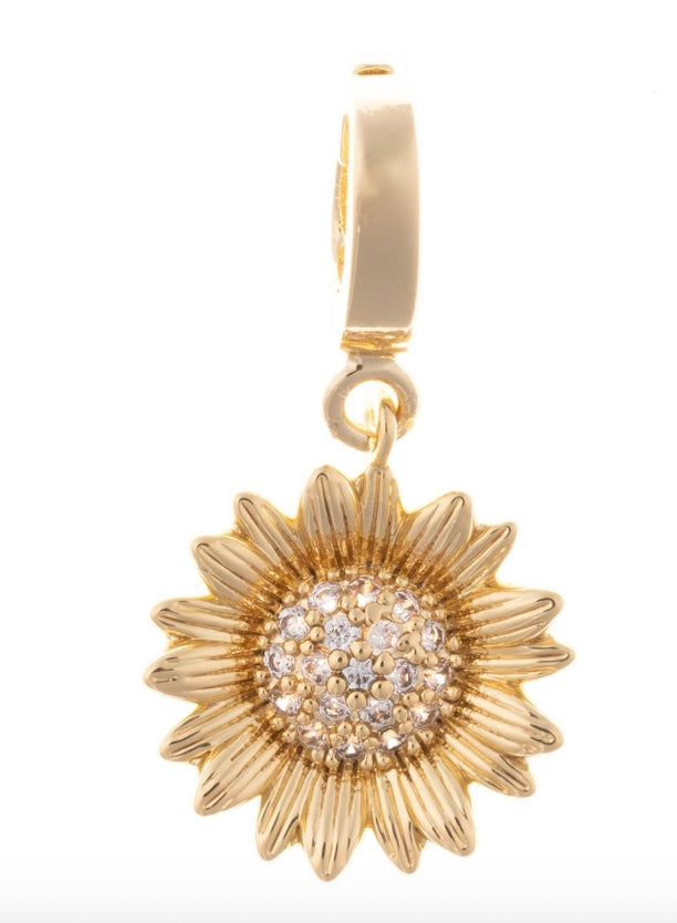 Gold sunflower-shaped pendant with clear stones on a white background