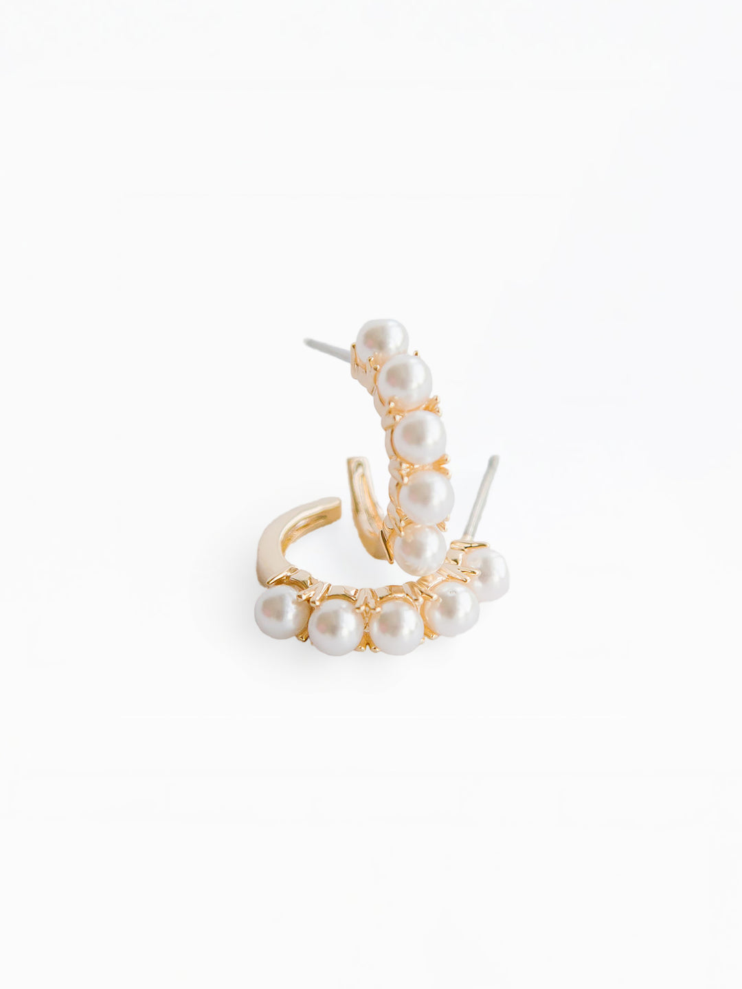 Gold and pearl earring on a white background