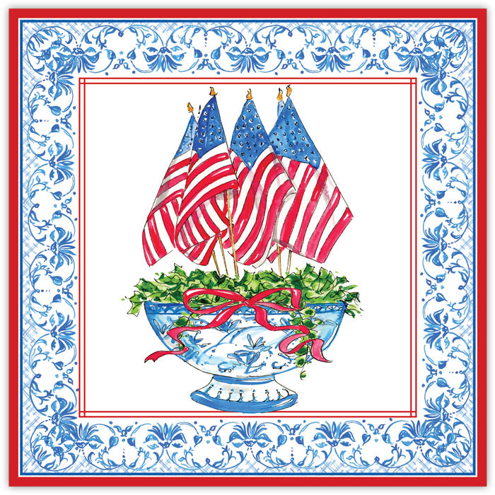 Decorative Roseanne Beck Paper Placemat with American flags, a blue urn, and floral arrangement on a decorative border.