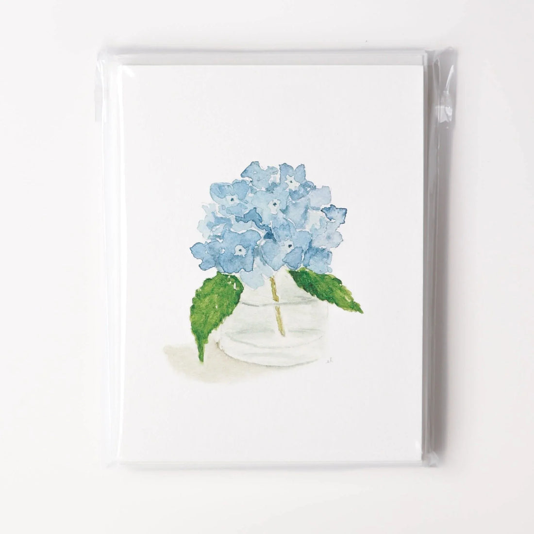 Card with a watercolor illustration of blue hydrangeas in a clear vase on a white background
