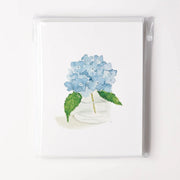Card with a watercolor illustration of blue hydrangeas in a clear vase on a white background