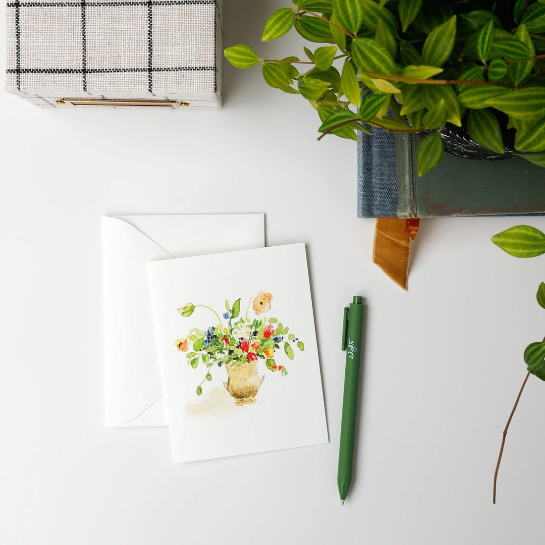 Greeting card with floral design, envelope, pen, and plant on a white surface - Emily Lex 